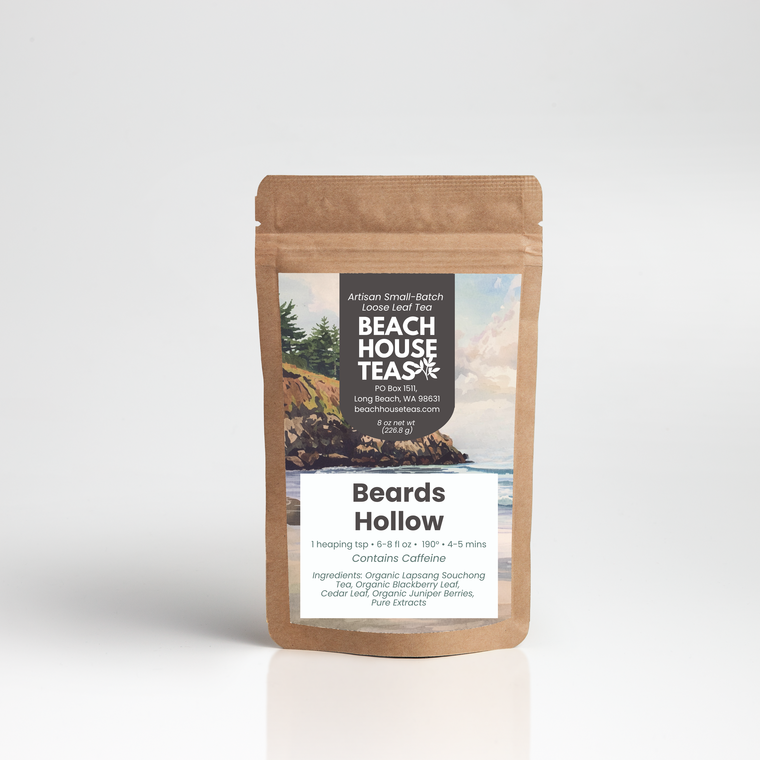 A stand-up kraft paper pouch of Beach House Tea Co. Beards Hollow tea, featuring a scenic label with a rocky coastline and beach, set against a clean white studio background.