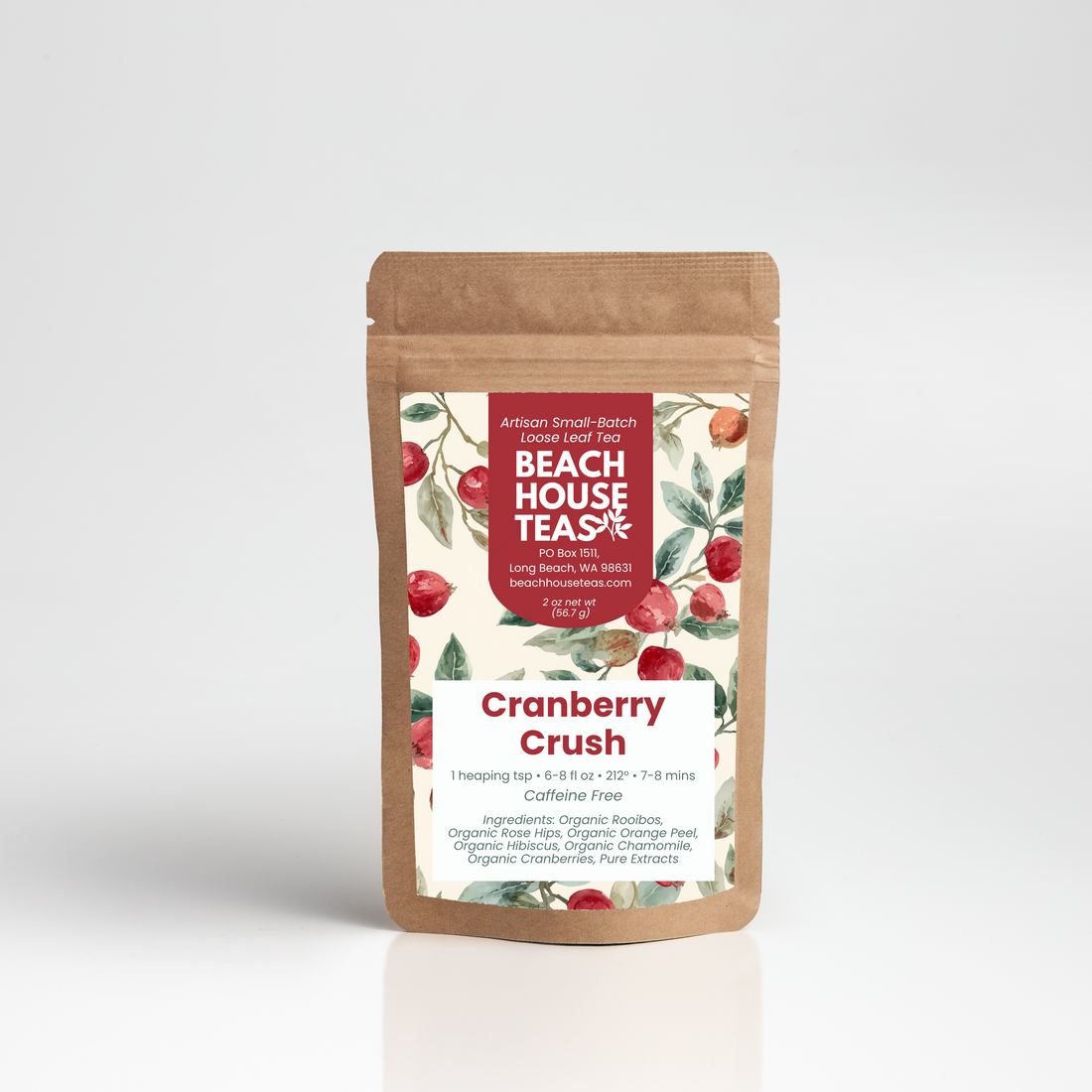 A stand-up kraft paper pouch of Beach House Teas Cranberry Crush loose-leaf tea, featuring a white label with red text and illustrations of red cranberries on a light gray background.