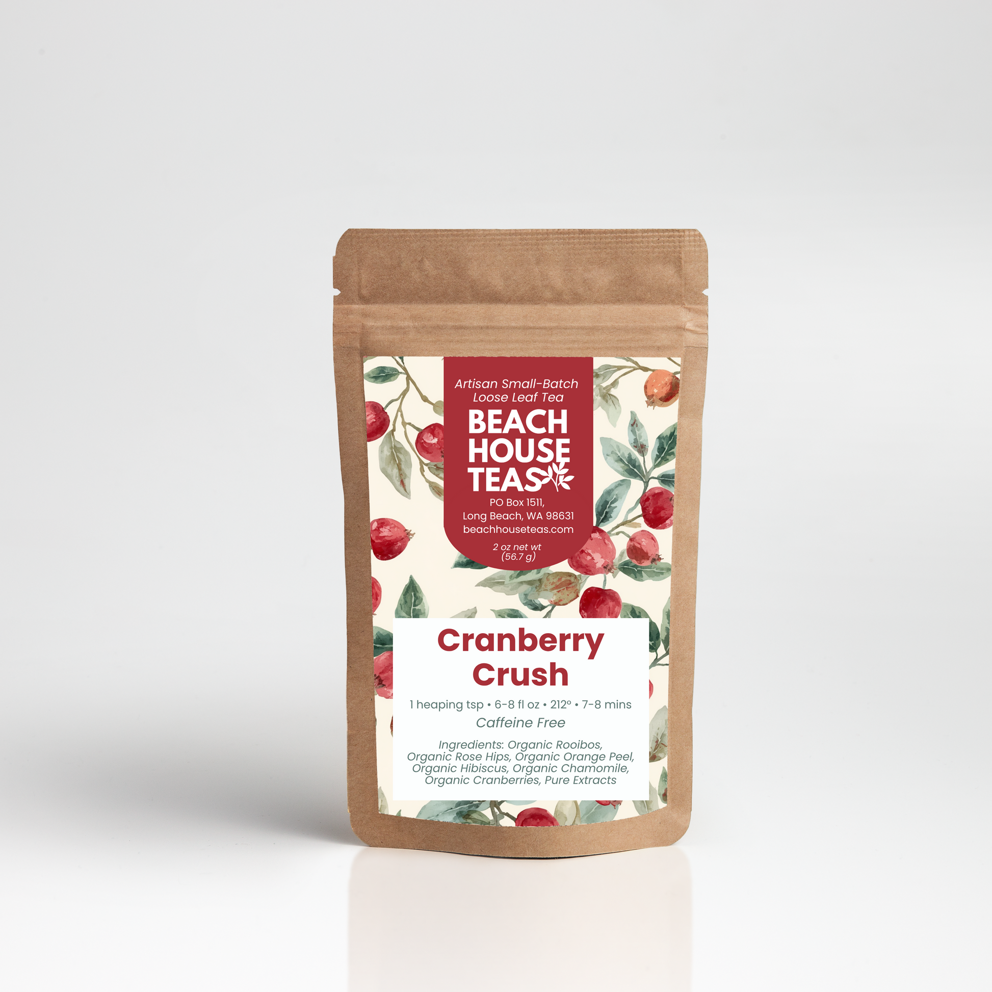 A stand-up kraft paper pouch of Beach House Teas Cranberry Crush loose-leaf tea, featuring a white label with red text and illustrations of red cranberries on a light gray background.