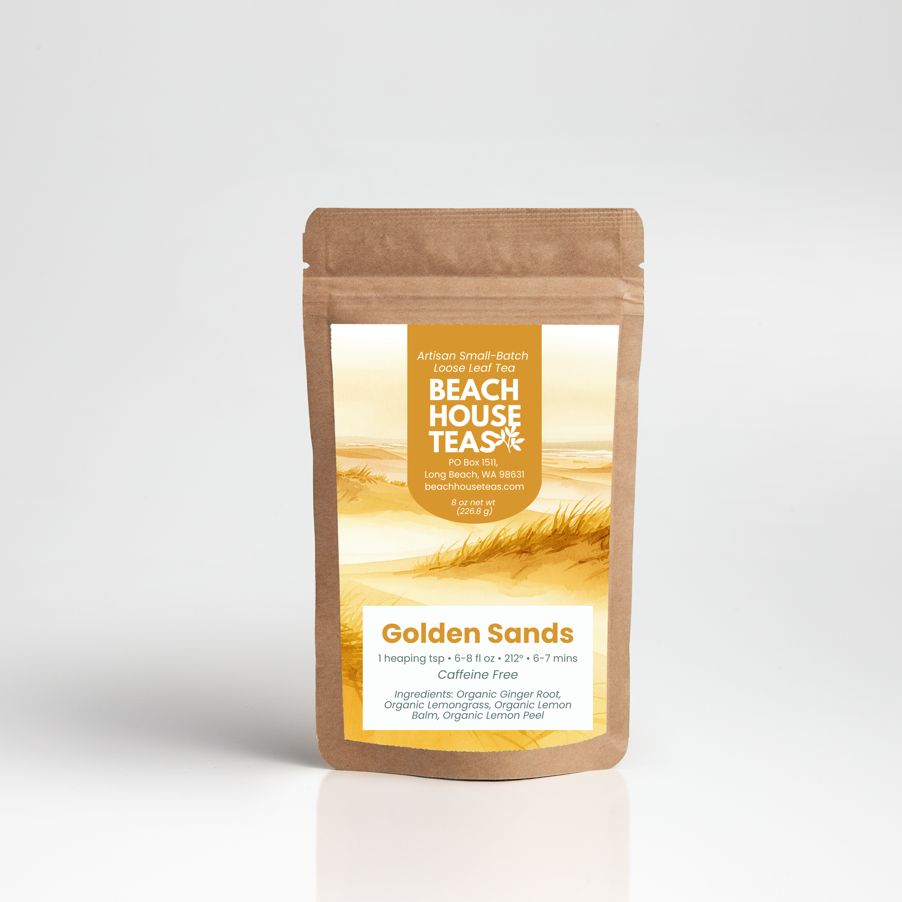 A stand-up kraft paper pouch of Beach House Tea% Golden Sands herbal tea, featuring a warm yellow and orange label with a wheat field graphic, set against a clean white background.