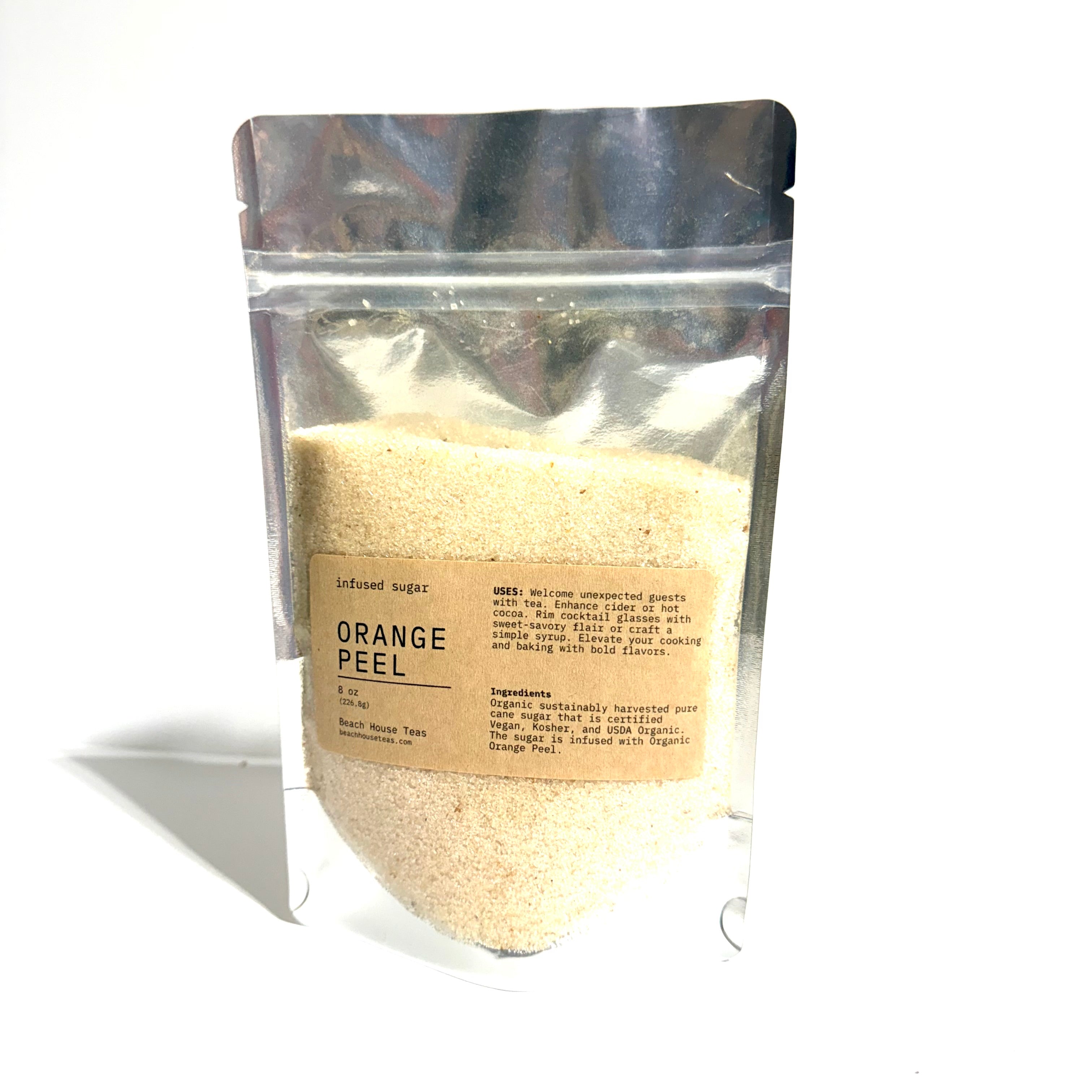 A stand-up resealable pouch filled with a light beige powder, labeled 'ORANGE PEEL' by Inbound Sugar, photographed on a white background with a soft shadow.