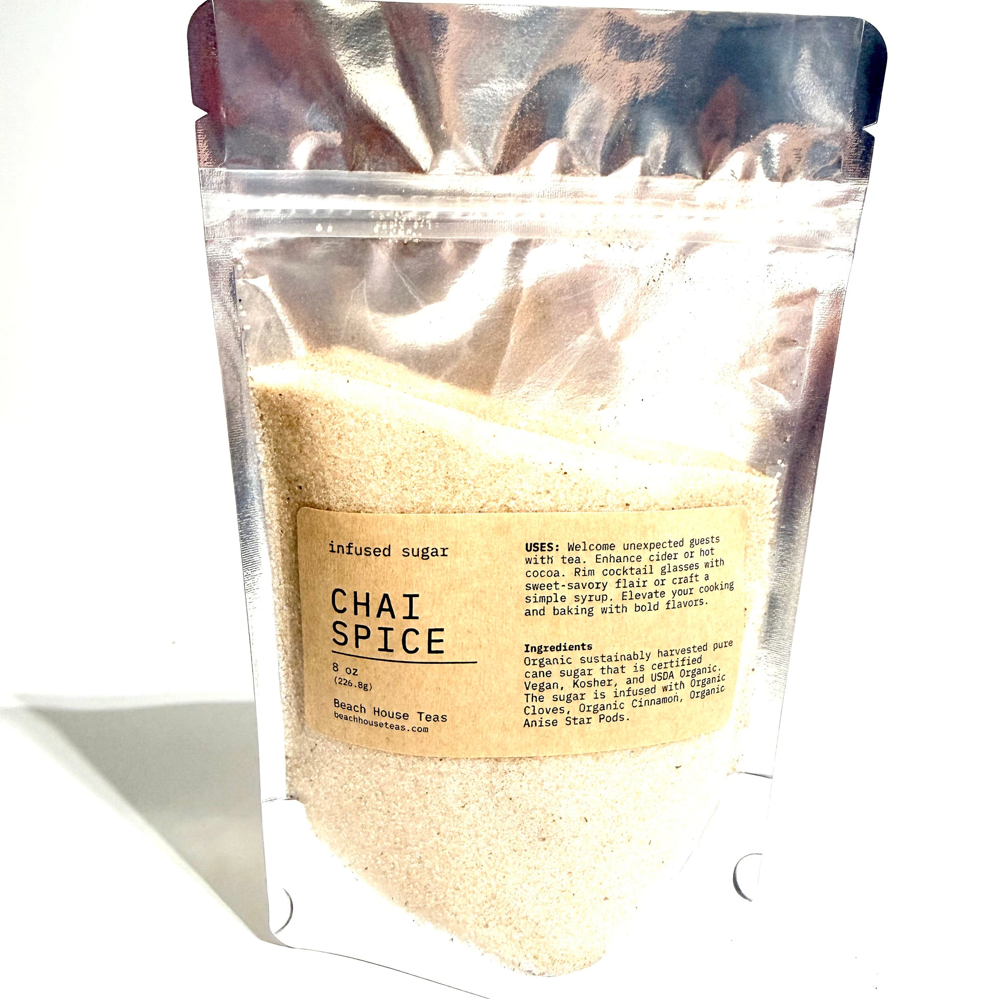 A stand-up resealable pouch of infused sugar labeled 'Chai Spice' filled with light beige granulated sugar, photographed on a white background.