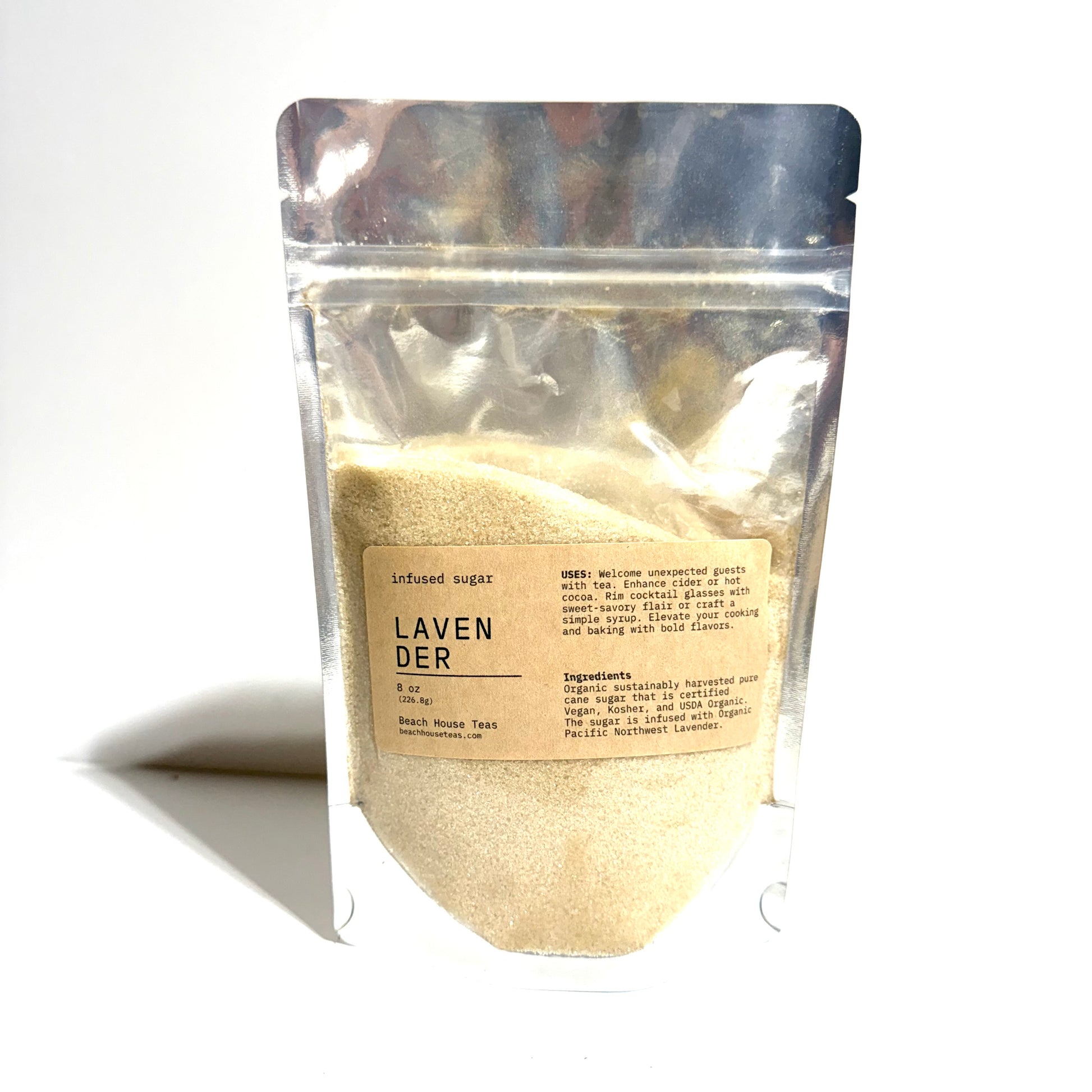 A stand-up resealable pouch of Lavender-infused sugar on a white background. The pouch is made of reflective silver plastic, showing a pale beige powder inside.