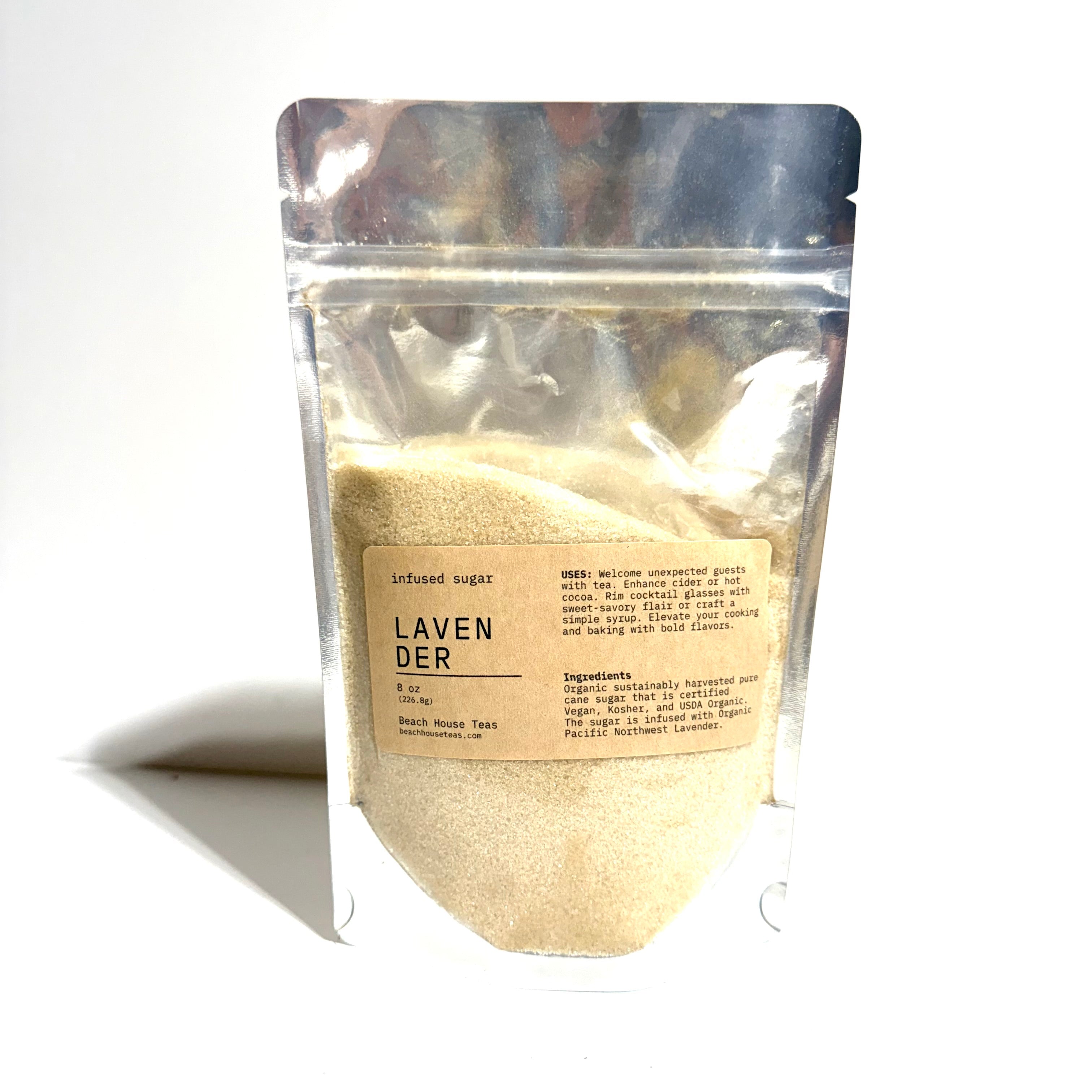 A stand-up resealable pouch of Lavender-infused sugar on a white background. The pouch is made of reflective silver plastic, showing a pale beige powder inside.