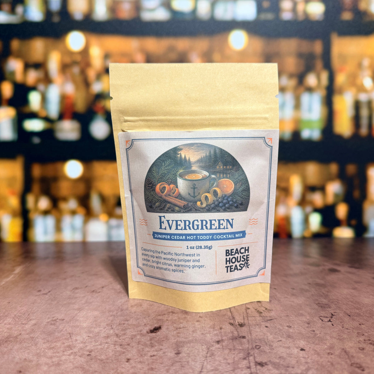 Evergreen juniper cedar hot toddy cocktail mix by Beach House Teas, 1 oz pouch on a bar counter.