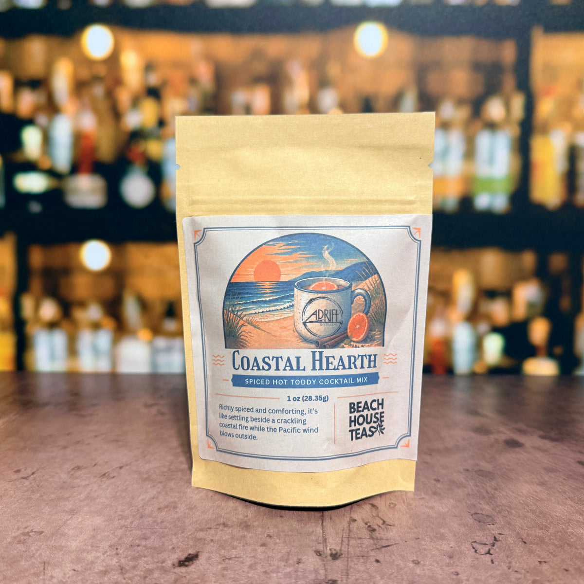 Coastal Hearth spiced hot toddy cocktail mix by Beach House Teas, 1 oz pouch on a bar counter.