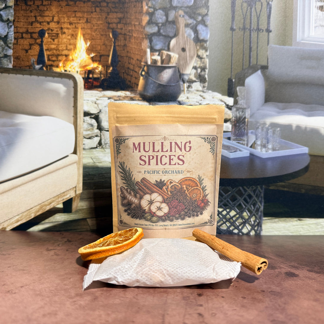 Pacific Orchard Mulling Spices pouch on a table in front of a stone fireplace.