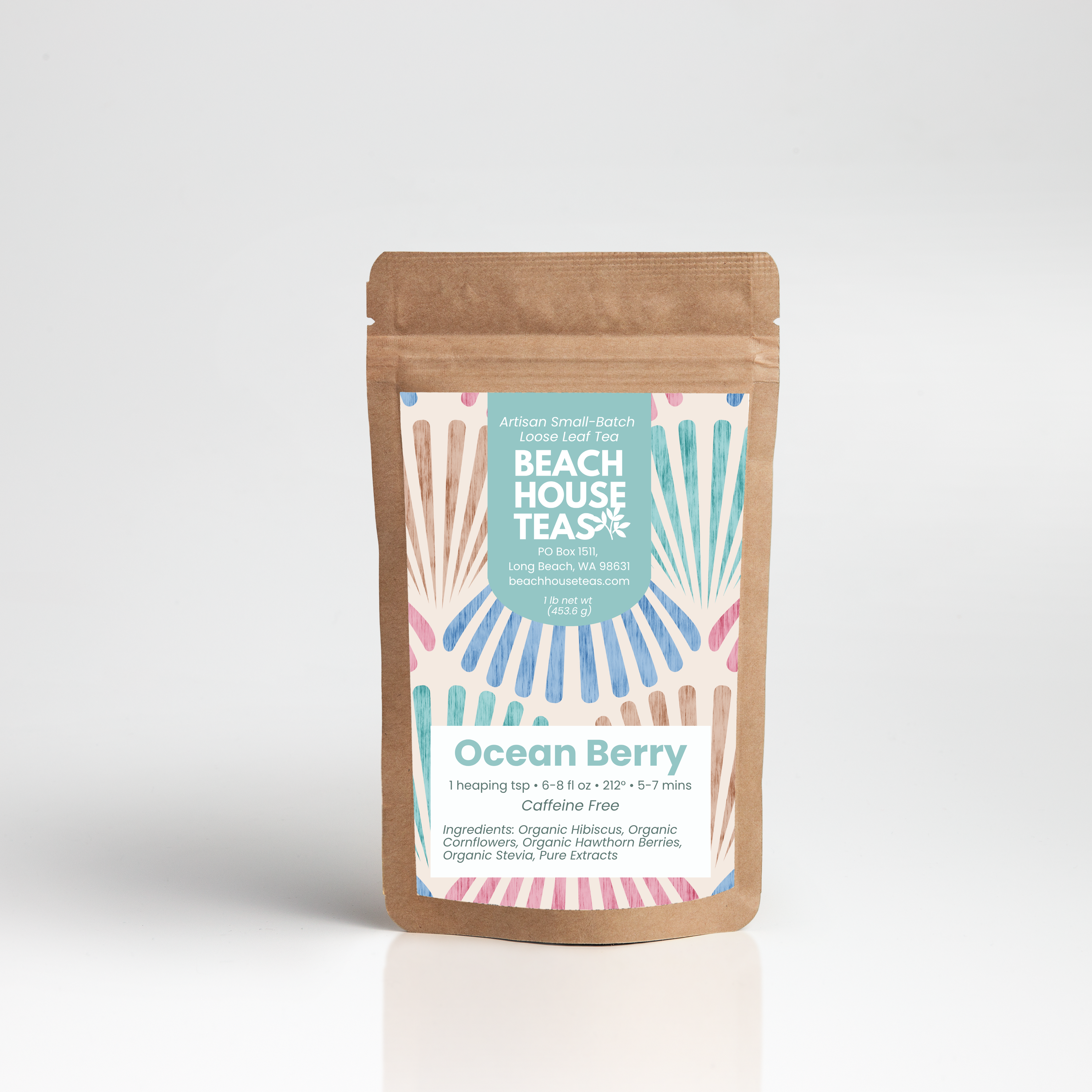 A stand-up kraft paper pouch of Beach House Teas Ocean Berry herbal tea, featuring a colorful retro fan-pattern label, set against a clean white studio background with a soft reflection.
