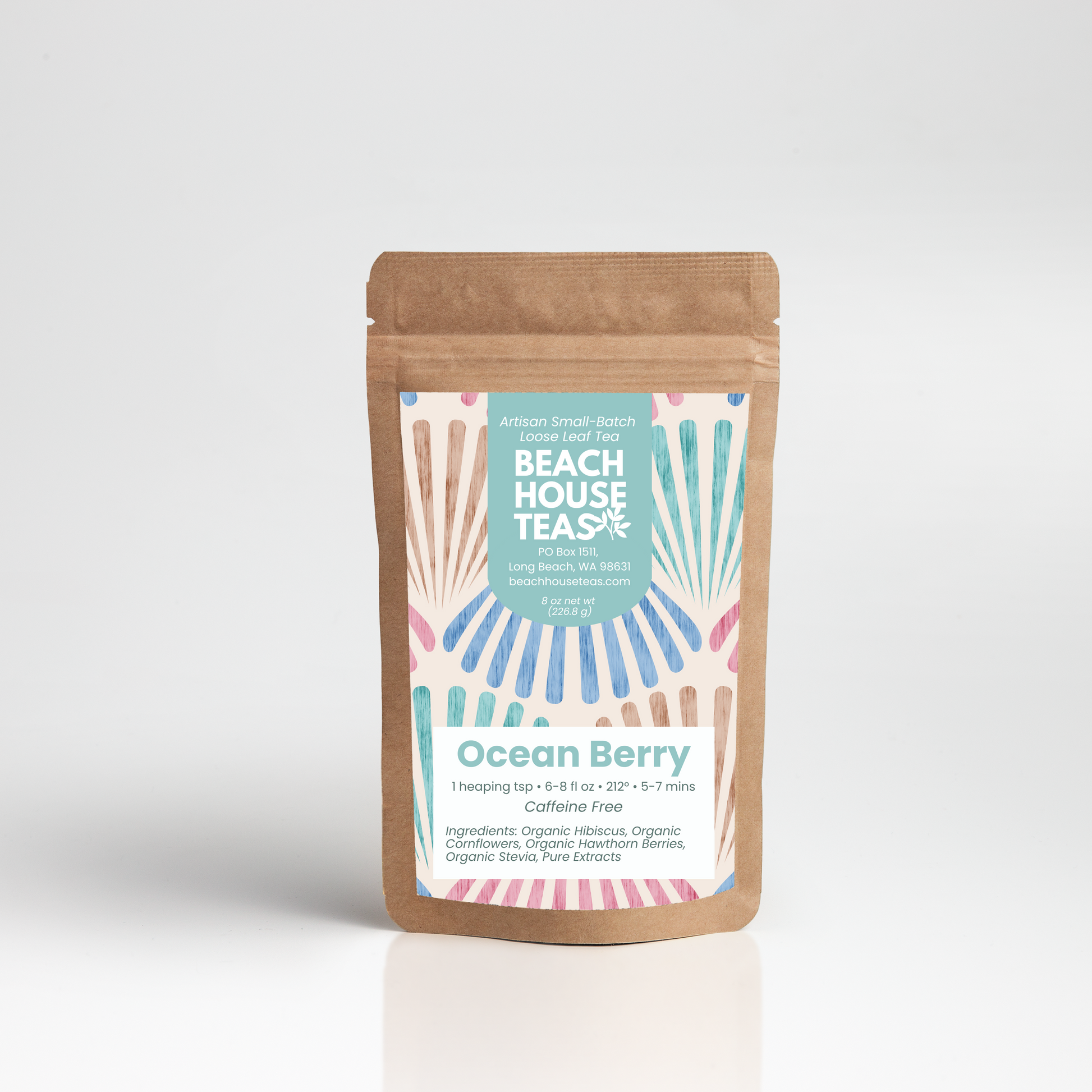 A stand-up kraft paper pouch of Beach House Teas Ocean Berry cold-brew tea, featuring a colorful label with a retro fan pattern in pink, blue, and orange on a light gray background.