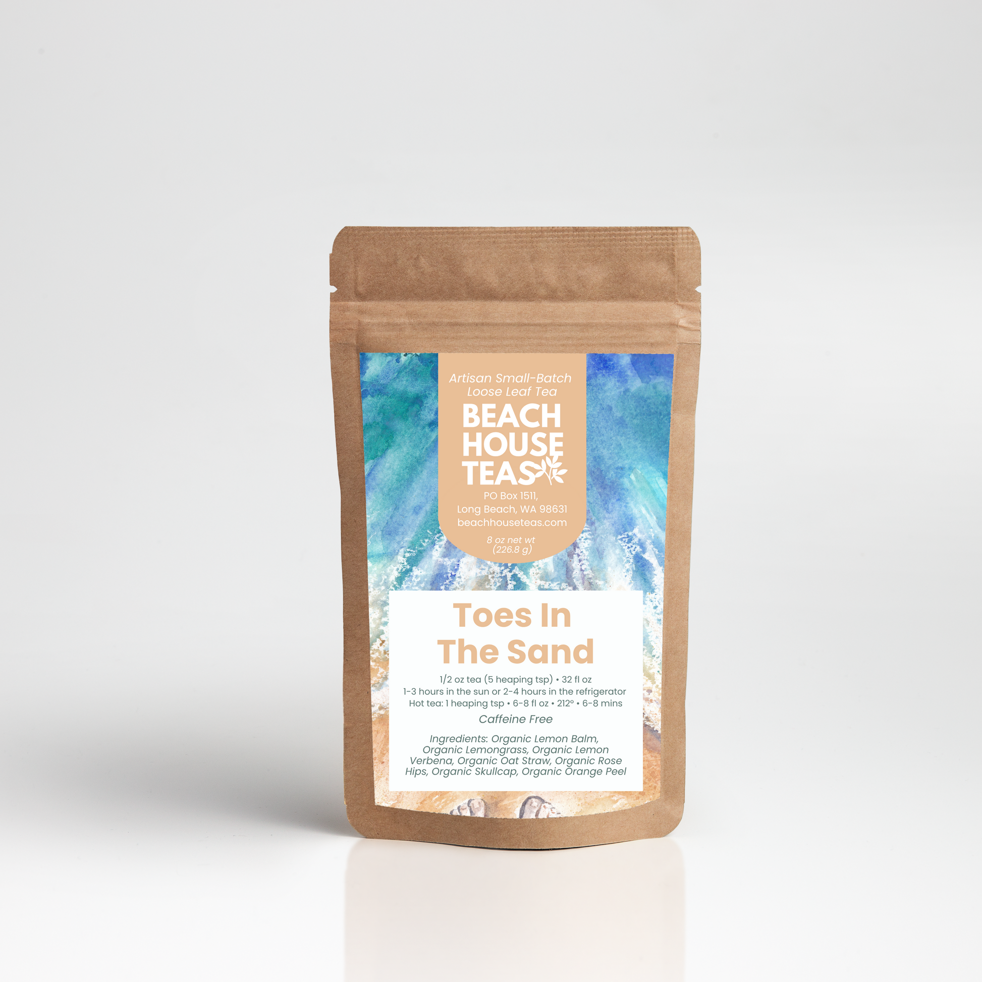 A stand-up kraft paper pouch of Beach House Tea Co. 'Toes In The Sand' tea, featuring a blue and white tropical wave label on a light gray background.
