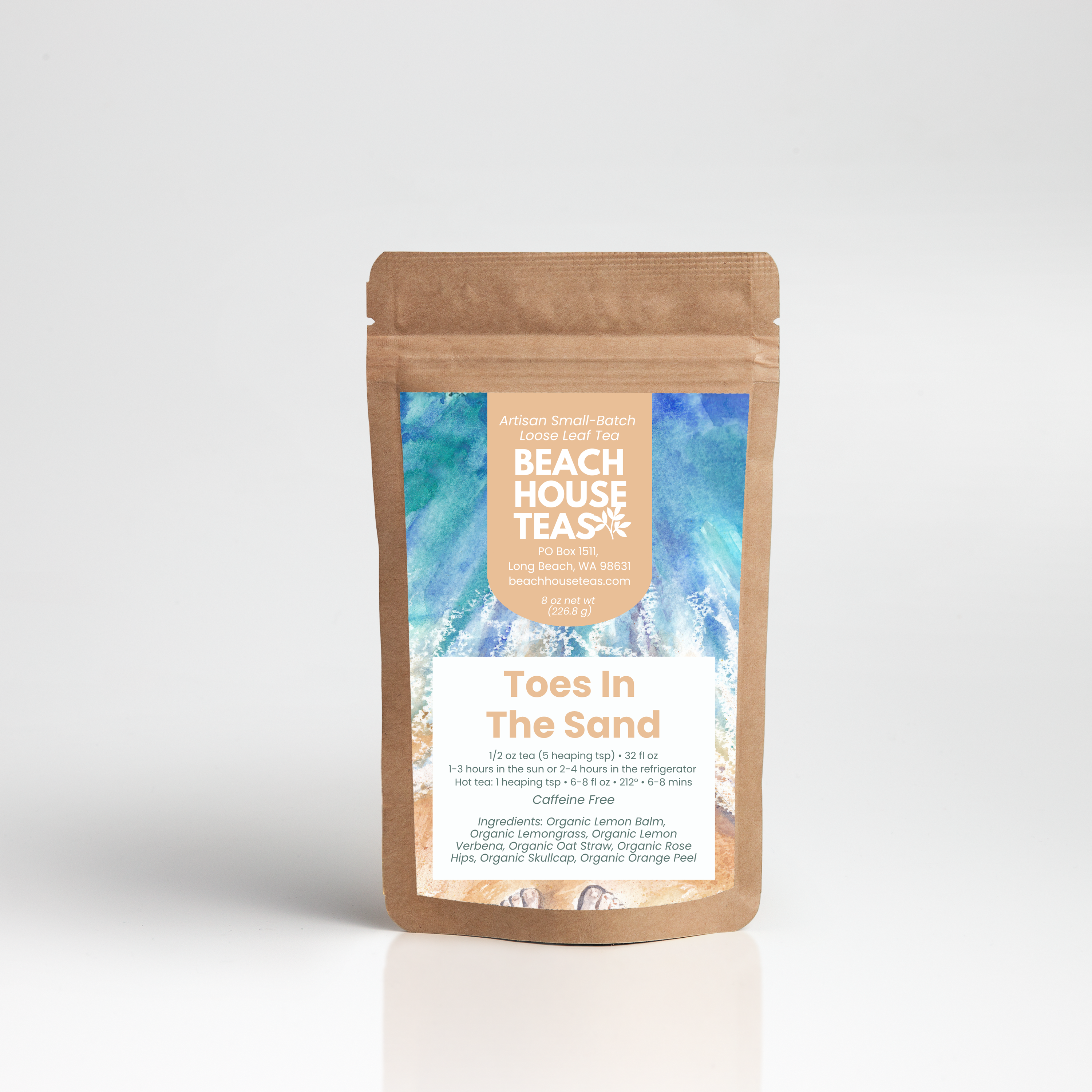A stand-up kraft paper pouch of Beach House Tea Co. 'Toes In The Sand' tea, featuring a blue and white tropical wave label on a light gray background.
