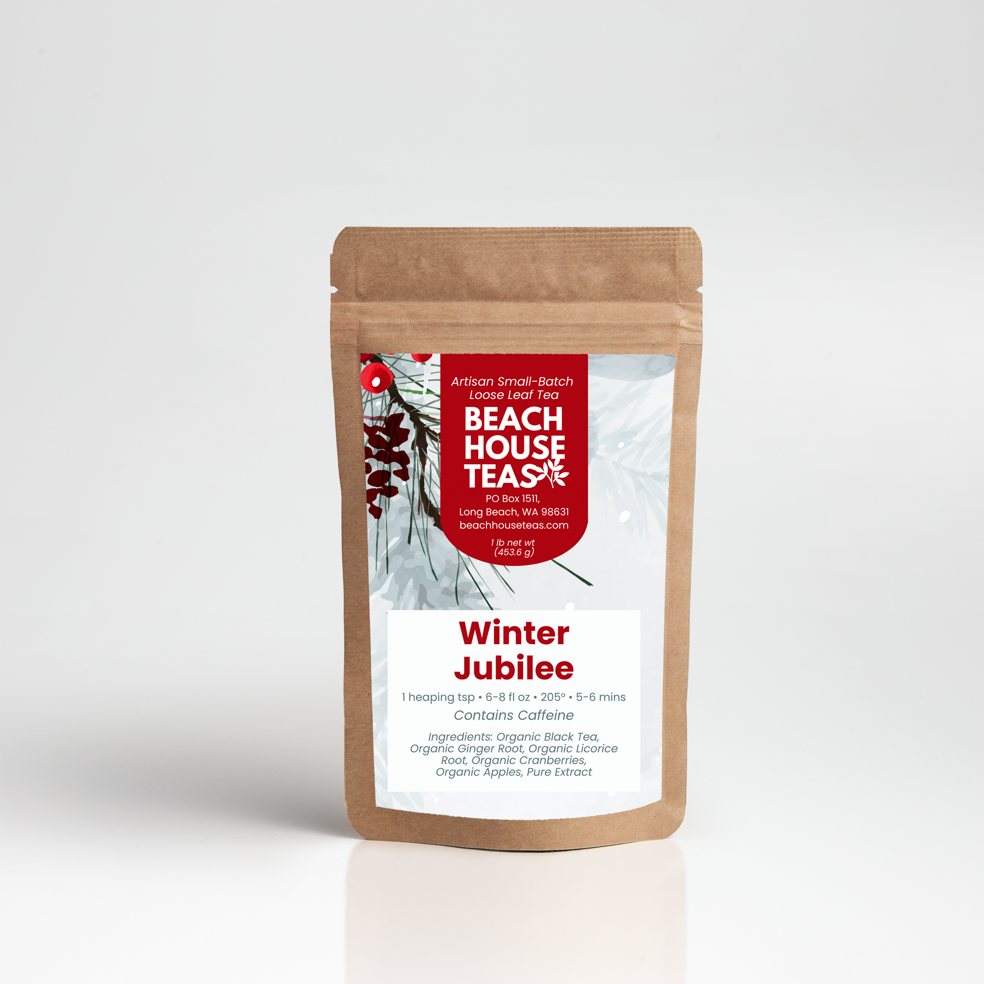 A stand-up kraft paper pouch of Beach House Tea Company's Winter Jubilee loose-leaf tea, shown on a clean white studio background with a soft reflection.