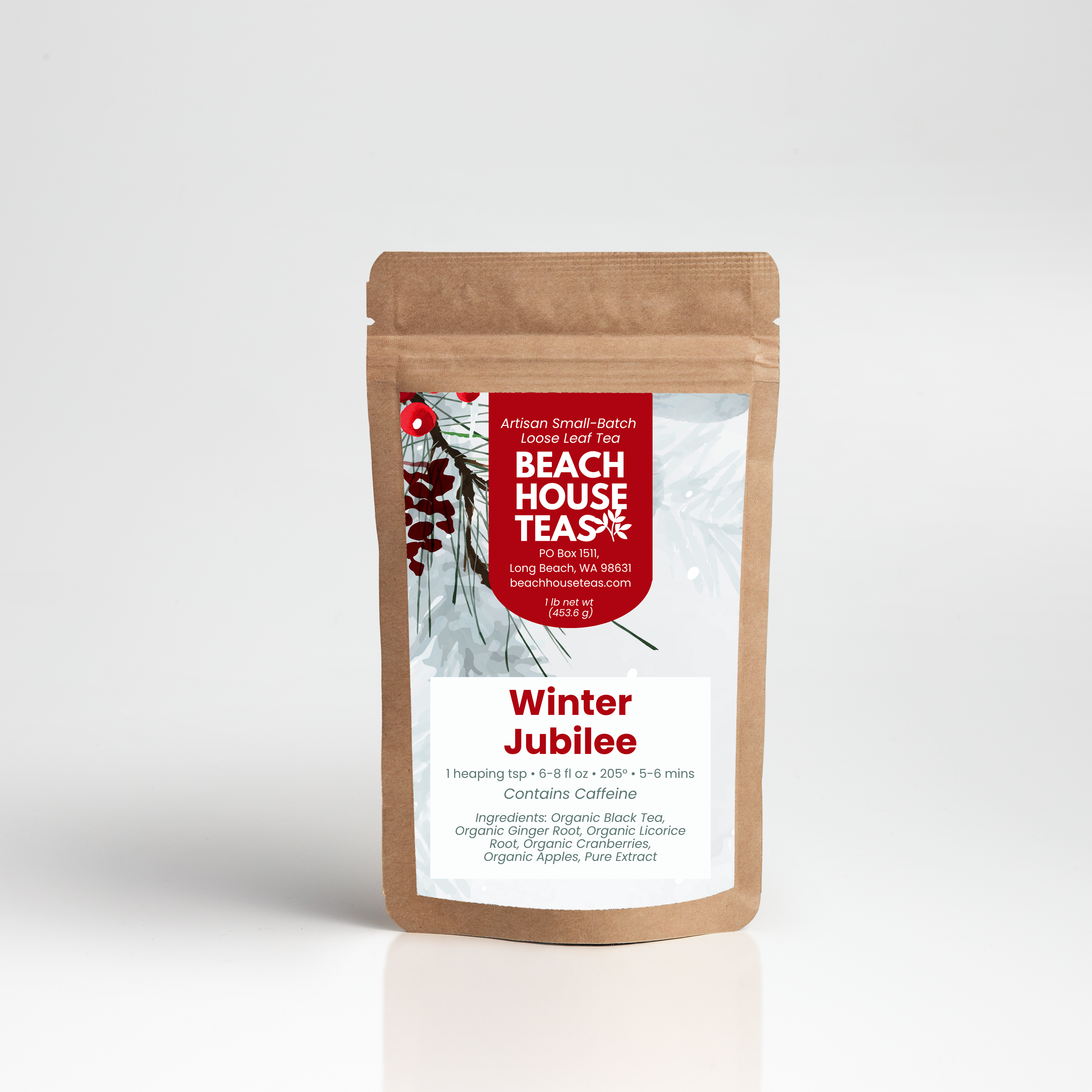 A stand-up kraft paper pouch of Beach House Tea Company's Winter Jubilee loose-leaf tea, shown on a clean white studio background with a soft reflection.