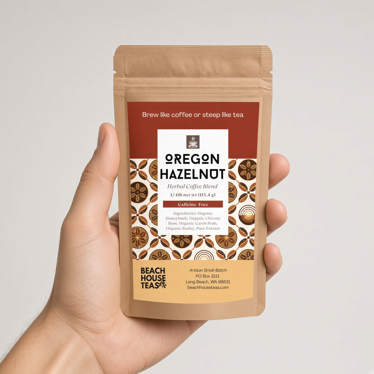 Hand holding an Oregon Hazelnut herbal coffee quarter-pound kraft pouch against a light background