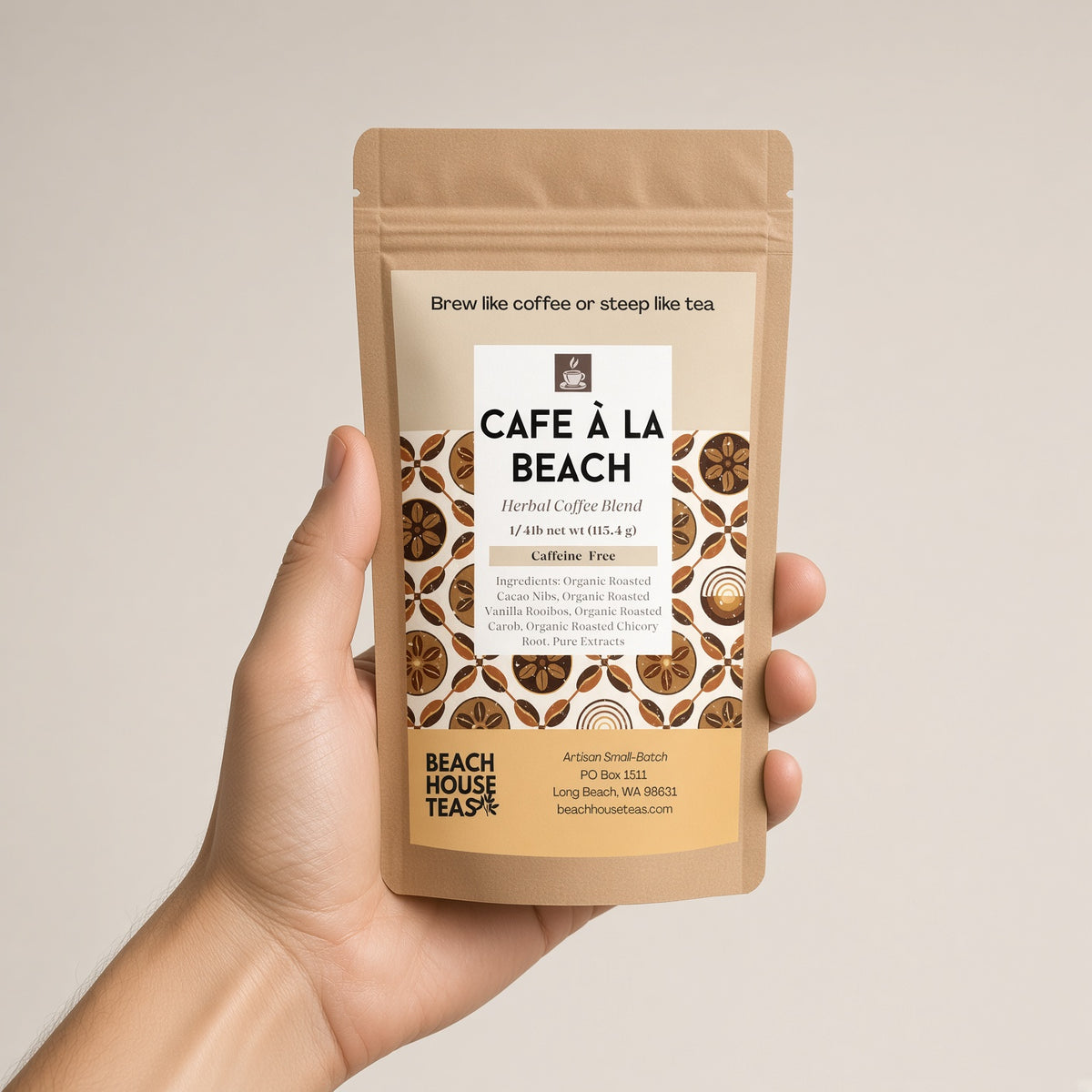 Hand holding a Café à la Beach Herbal Coffee pouch against a light background
