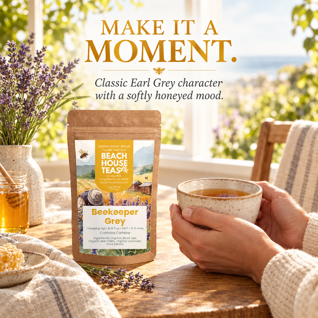 Hands holding a ceramic tea cup beside a Beekeeper Grey pouch, lavender and honey in a sunny breakfast nook.