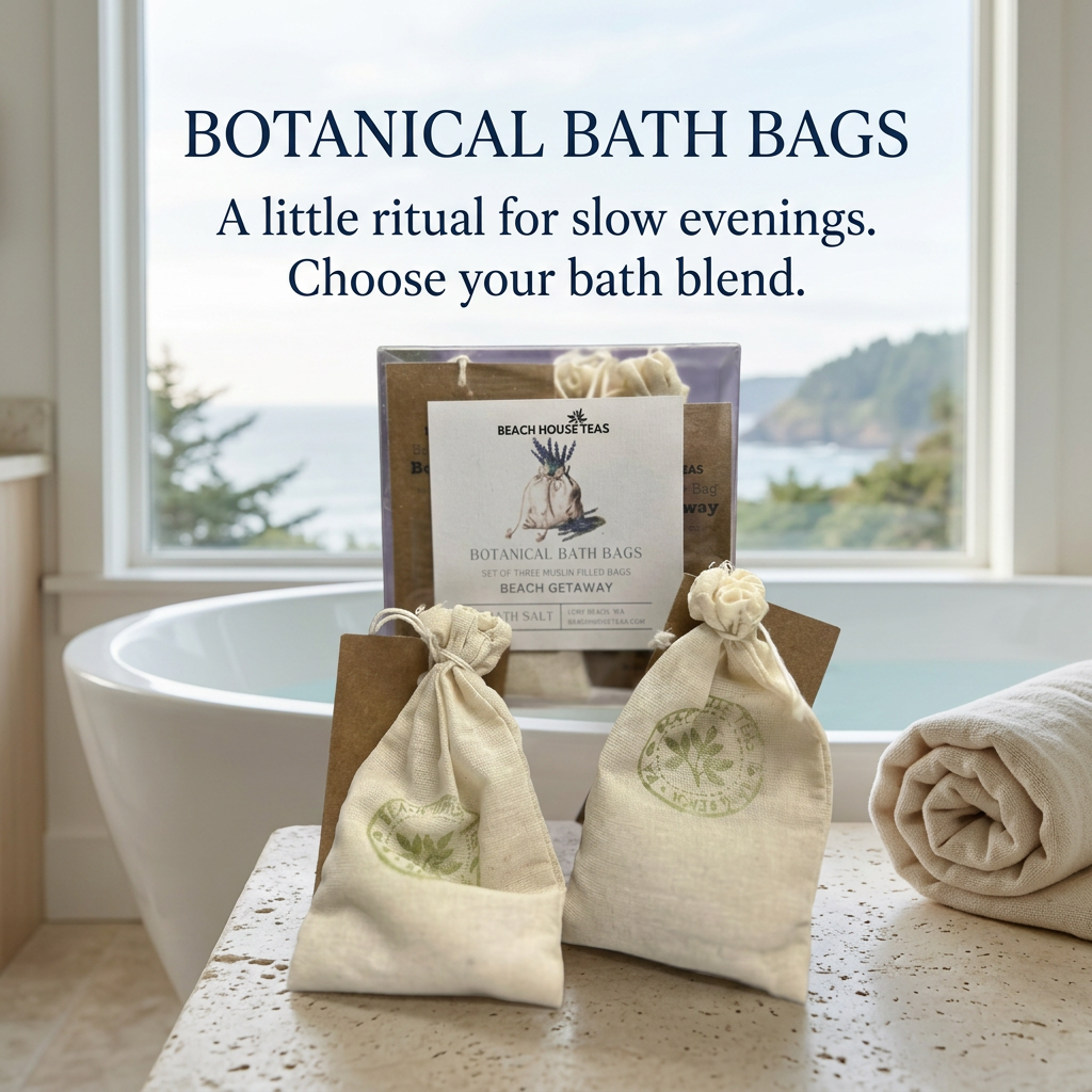 Beach Getaway botanical bath bags in a clear gift box with a brown tag beside a metal watering can and purple flower