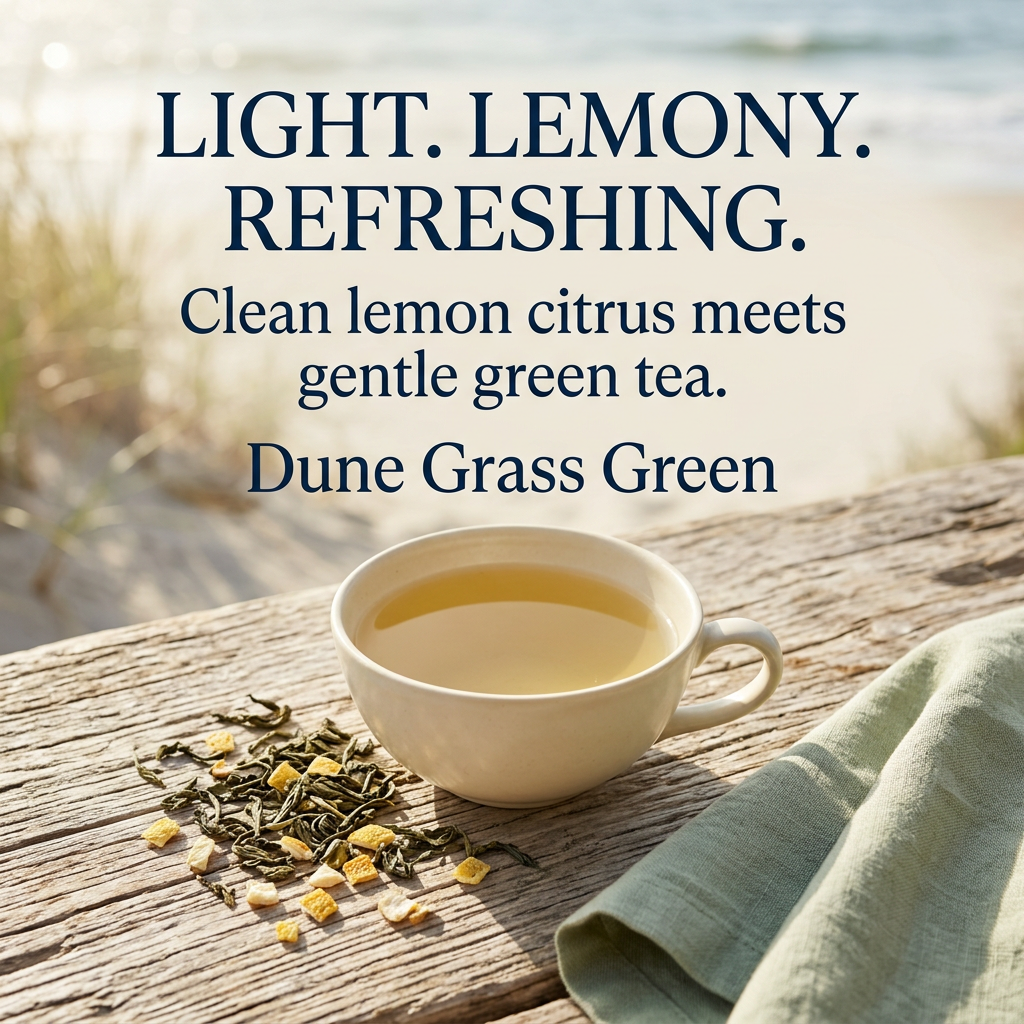 Cream cup of golden green tea beside dried green tea leaves and lemon peel on weathered wood with sage linen and softly blurred dunes. Light. Lemony. Refreshing. Clean lemon citrus meets gentle green tea. Dune Grass Green.