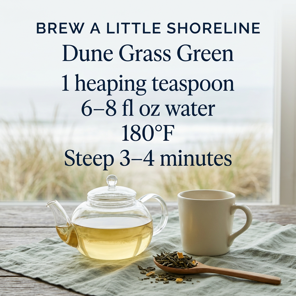 Dune Grass Green brewing guide: 1 heaping teaspoon, 6–8 fl oz water, 180°F, steep 3–4 minutes. Glass teapot of golden tea beside a cream mug and wooden spoon of loose tea on sage linen at a coastal window.